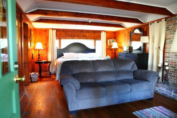 Cottage 7 features a king bed, queen sofa bed, wood-burning fireplace, fully equipped kitchen, and back patio.