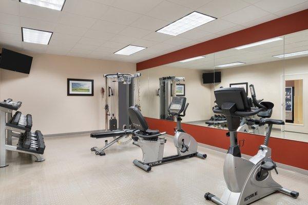 24-hour exercise room with cardio and free weights