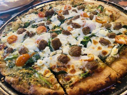 Cauliflower crust goat cheese pesto sauce with added sausage pizza