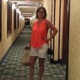 Vacation girl sporting our hot orange tank, large brown wristlet w/monogram