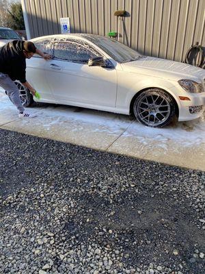 Chris cleaning up the Mercedes