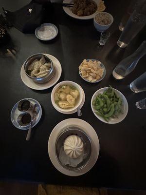 Pork bun, dumplings, wonton soup, edamame, orange chicken.