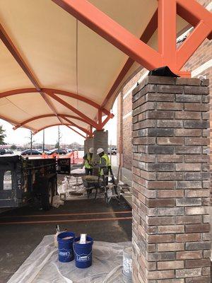 Empty grout joints on the right. That is the last step of the thin veneer application.