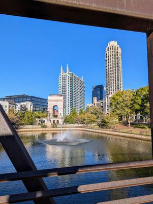 Atlantic Station bridge, pond, and fountain with Millennium Gate Museum (arch) in background. Friday, October 18, 2024 at 5:23 PM EDT.