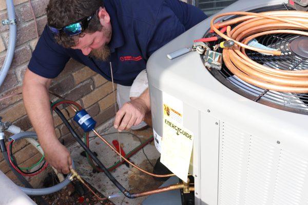 Installing a new condenser for a homeowner