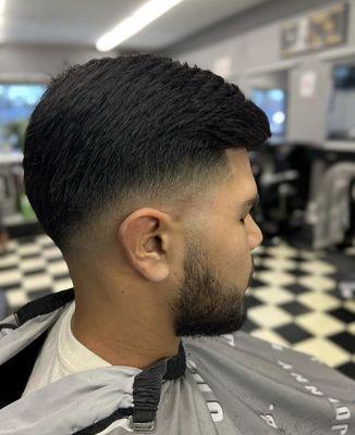 Medium skin fade with a mild drop.