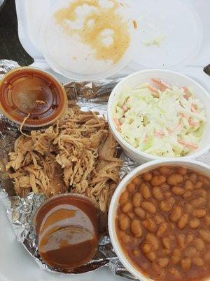 Turkey dinner with coleslaw and baked beans.