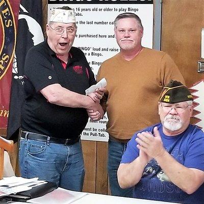 Shawn Osborne, President of Osborne Financial Group, presents a donation to VFW Post 3404 from Nixa Wrestling Club.