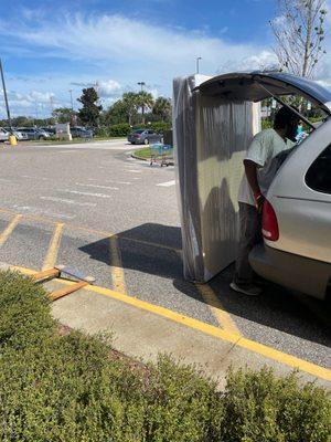 Purchased a box spring. He helped us tie it to the van.