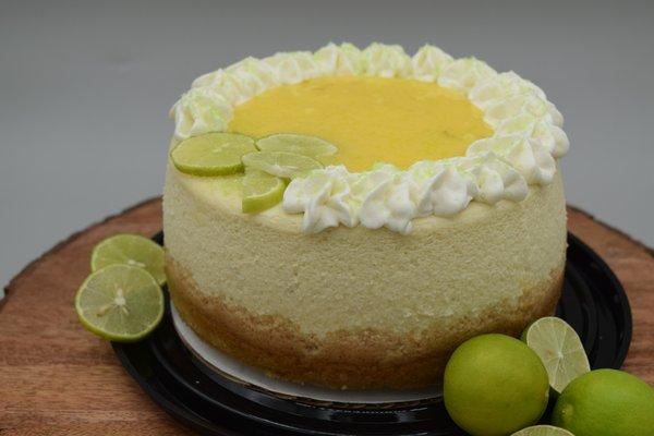 Mini Key Lime Cheesecake with a lime curd topping and whipped cream.