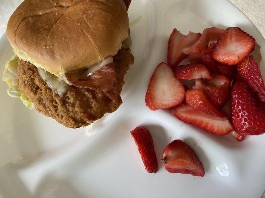 Hot Honey Chicken Sandwich with a side of strawberries