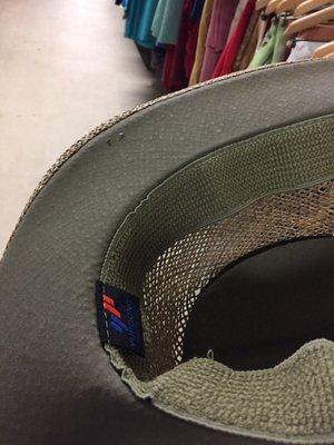 Staple for tag sticking out of hat brim