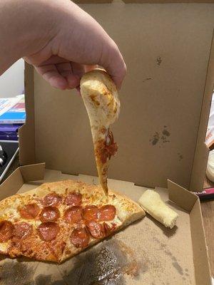 Hmm, something appears to be a little off about this slice too! It must be a makeshift breadstick with a sliver of pizza connected to it.