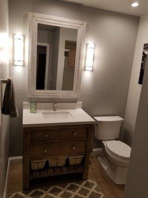 Bathroom sconce and can lighting.