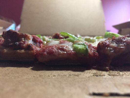 sausage & green pepper on thin crust pizza. Taken from side to show thickness (they offer 3 thicknesses).