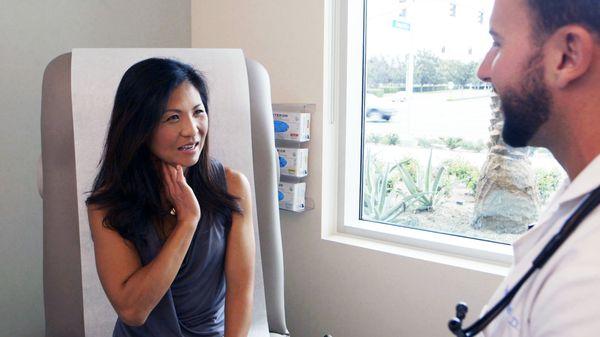 Dr. McAtee listening to a patient's symptoms.