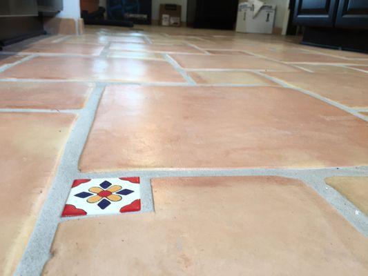 True Saltillo tile flooring with random accent tiles.