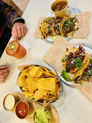 4 queso tacos with consommé combo, two added tacos and the chips trio.