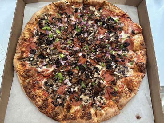 Large supreme pizza with extra mushrooms