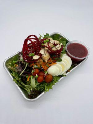 Telos Mothership Salad - Salad greens, carrots, microgreens, beets, peas, hardboiled egg, almonds, hemp hearts, tomatoes w/ Vinaigrette