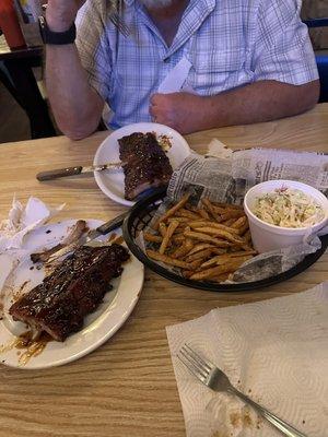 A full rack of delicious Ribs hot fries and generous coleslaw!