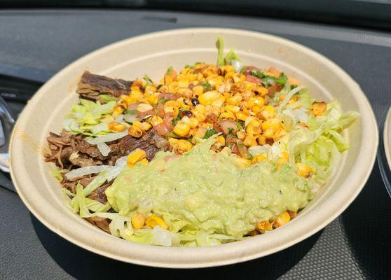 Steak burrito bowl with added guacamole and charred corn- $15