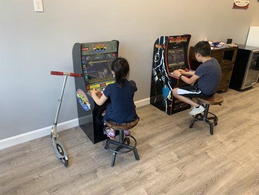 Children playing arcaded games at A Man's Zone Barber Shop