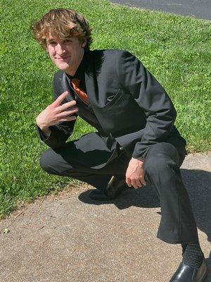 Matte black suite with satin collar and paisley vest. Tie was his own.