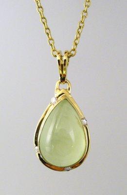 Subtle prehnite in 18k yellow gold accented by diamonds.