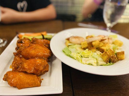 Chicken wings and Caesar salad