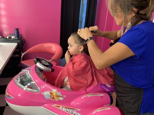 My daughter getting her hair trimmed by Aida.