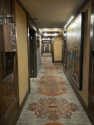 Hallway adorned with interesting paintings