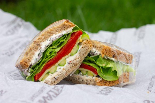 Spring Vegetable Sandwich - red pepper, marinated cucumber, asparagus, red onion, lettuce, goat cheese & olive spread, on 7 Grain & Flax.