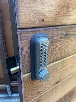 Mechanical keypad lock installed on wooden gate