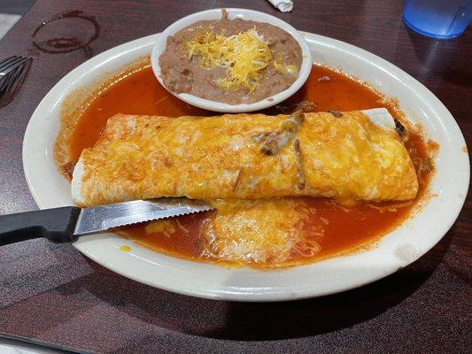 Smothered Steak Burrito with side of Refried Beans