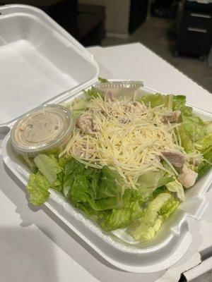 Chicken Caesar salad, really big and lots of toppings and dressing