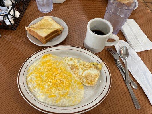 Two eggs over medium cheese grits and toast