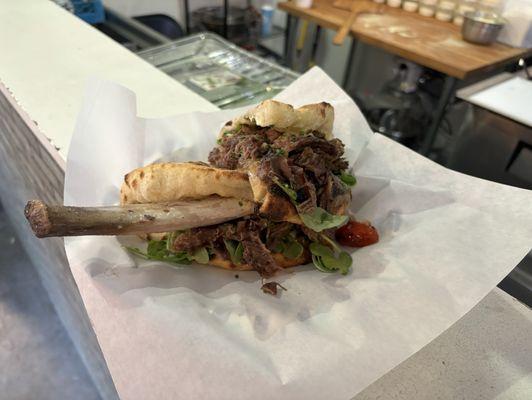 Braised rib sandwich with caramelized onions, cherry tomatoes, Monterey Jack cheese, and arugula 10/10