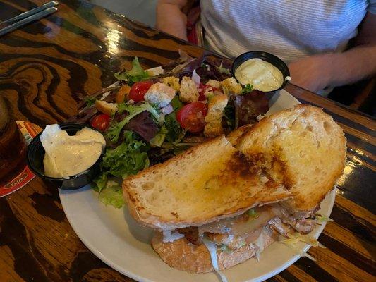 Chicken sandwich on sourdough with a side salad