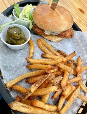 Fried chicken sandwich with reg. Fries. Candied jalapeños and lettuce on side.