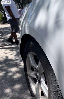 photo of left rear-side damage where the bumper was compressed by the lift