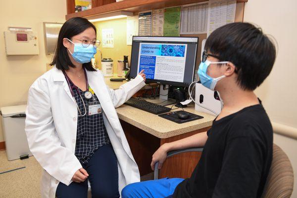 A CBWCHC provider shares information with a patient at our 45th Avenue location in Flushing.