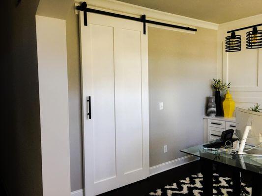 Shadow boxes + sliding barn door added to give this office space some more character