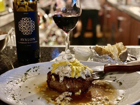 Theo's Special Filet. Filet topped with crabmeat, and their chefs bearnaise sauce. Baked potato and glass of wine. Divine!