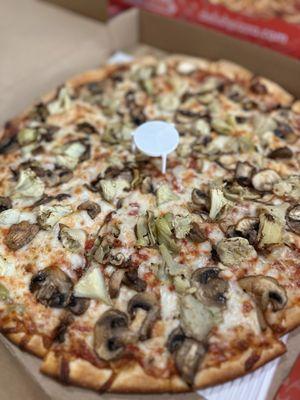 Large thin crust pizza with mushrooms and artichokes