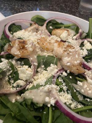 Spinach and grilled shrimp salad with warm bacon dressing.