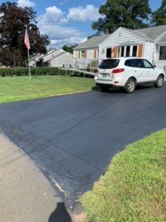 Driveway from the street with car.