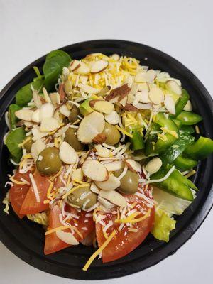 Harlequin Salad
 (The salad is made with fresh vegetables, olives, nuts, cheese, chicken breast and cheese. Ranch and Italian dressing)