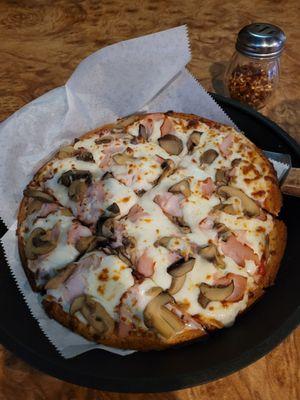 Gluten Free pizza with mushrooms and  Canadian bacon.