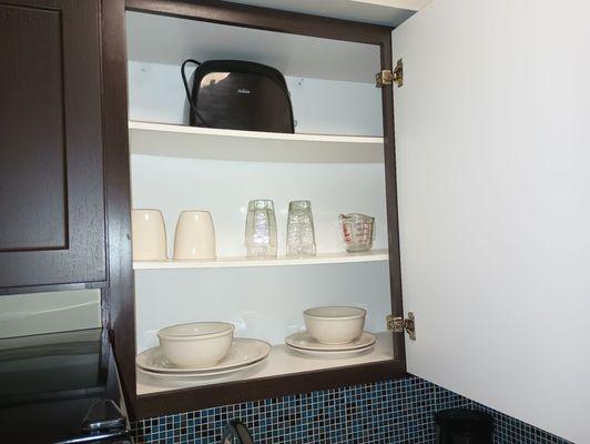 Toaster and dishes in kitchenette.